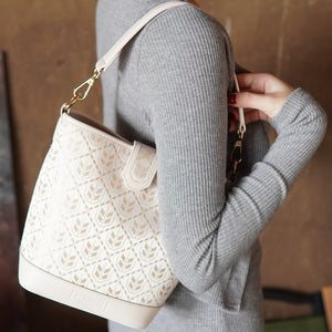 Model carrying multicolor brocade shoulder bag