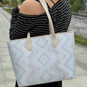 Model carrying multicolor brocade shoulder bag