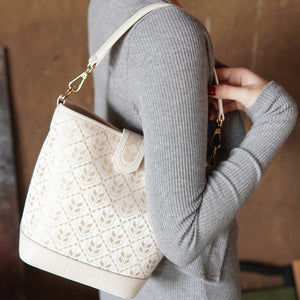 Model carrying multicolor brocade shoulder bag
