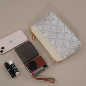 Silver lavender Wanjie crossbody bag with daily carry items for scale