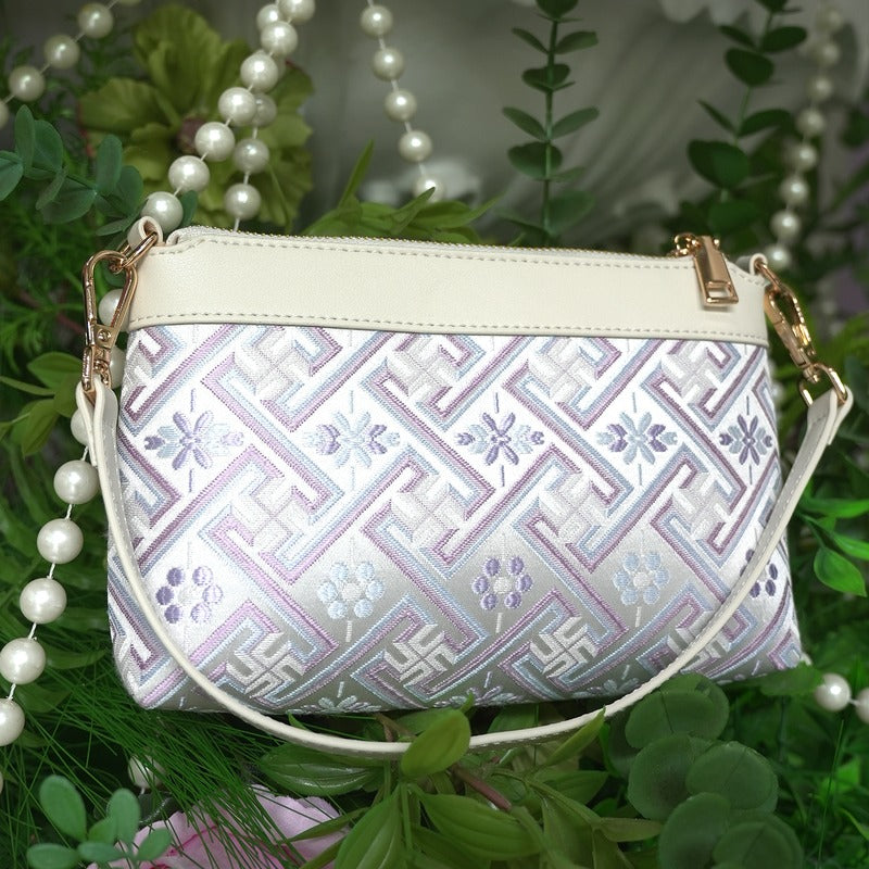Silver lavender Wanjie brocade-inspired crossbody bag front view with greenery styling