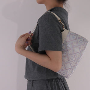 Model wearing silver lavender Wanjie crossbody bag on shoulder for scale