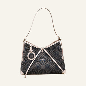 Deep blue butterfly flower brocade-inspired drawstring shoulder bag front view on warm neutral background