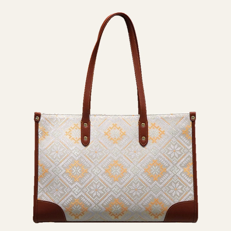 Four Swallows brocade-inspired work tote on warm neutral background