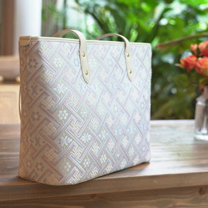 Silver purple Zhuang brocade tote in outdoor lifestyle setting