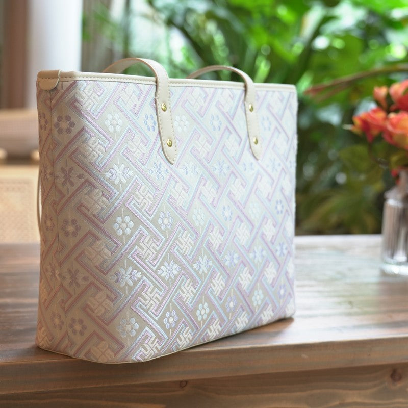 Silver purple Zhuang brocade tote in outdoor lifestyle setting
