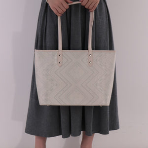 Model carrying ivory white brocade bag set