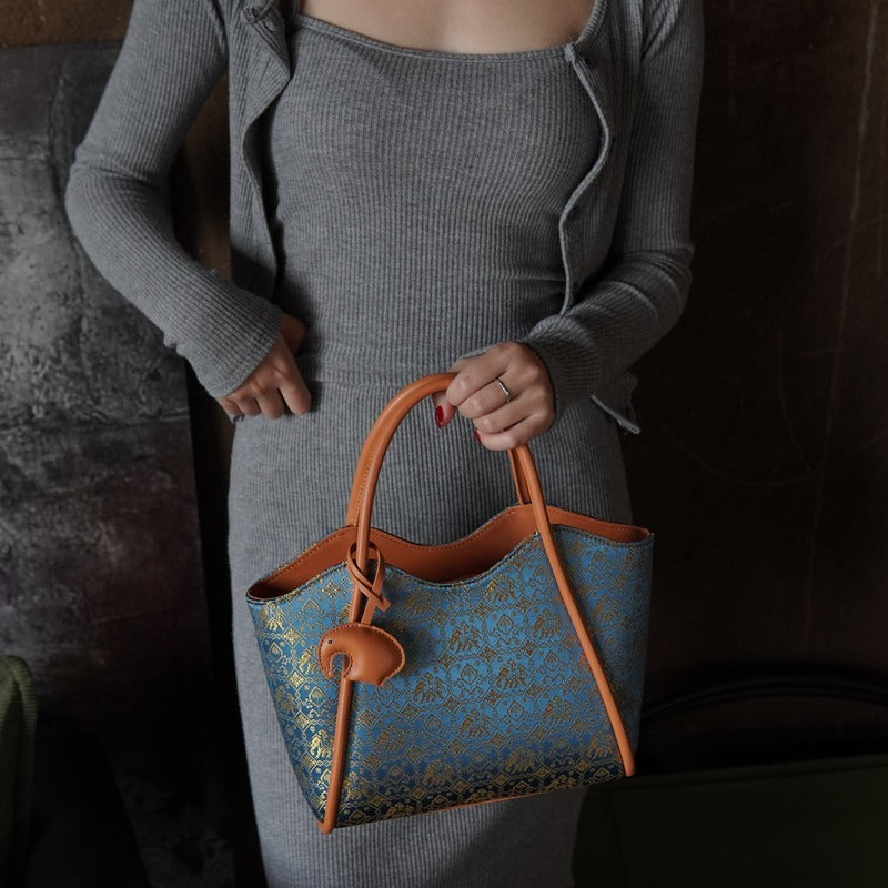 Model carrying multicolor brocade shoulder bag