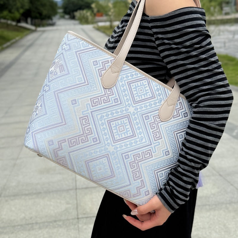 Model carrying multicolor brocade shoulder bag