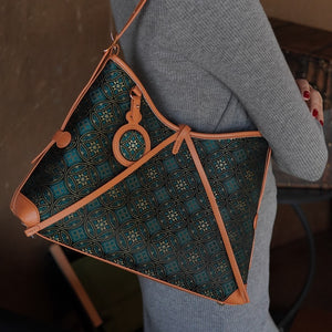 Model carrying multicolor brocade shoulder bag