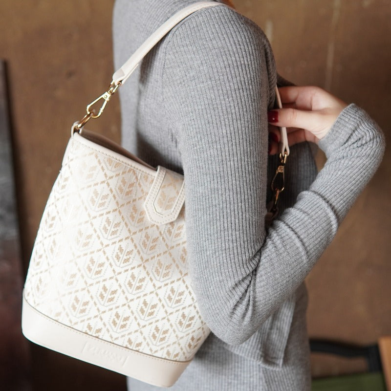 Model carrying multicolor brocade shoulder bag