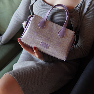 Model carrying multicolor brocade shoulder bag