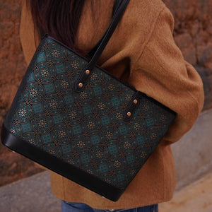 Model carrying multicolor brocade tote bag